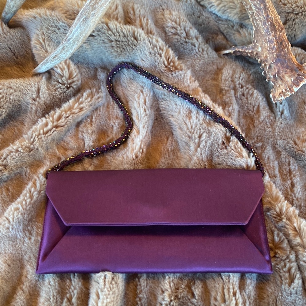NANCY BACICH Plum satin cutch with slim cord shaped matching beaded handle.